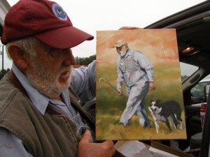 Handler Emil Luedecke with a painting done of him.